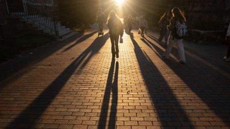 Person walking at sunset